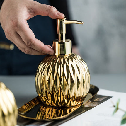 Modern ceramic soap dispenser gold for bathroom and kitchen.