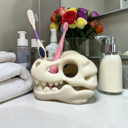 3D-printed dinosaur skull toothbrush holder, white.