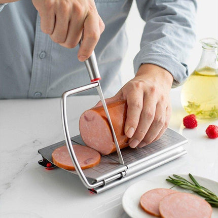 A stainless steel cheese slicer with scales-With scale.