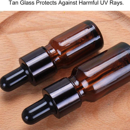 Compact Lightweight Tan Glass Dropper Bottle with Black Cap for Essential Oils and Perfume Travel.