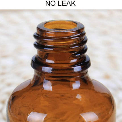 Compact Lightweight Tan Glass Dropper Bottle with Black Cap for Essential Oils and Perfume Travel.