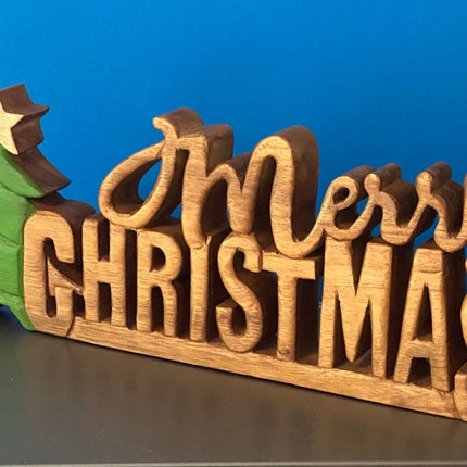 Wooden carved Merry Christmas decoration 38 cm long with Tree and Star.