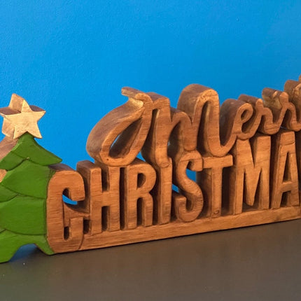Wooden carved Merry Christmas decoration 38 cm long with Tree and Star.