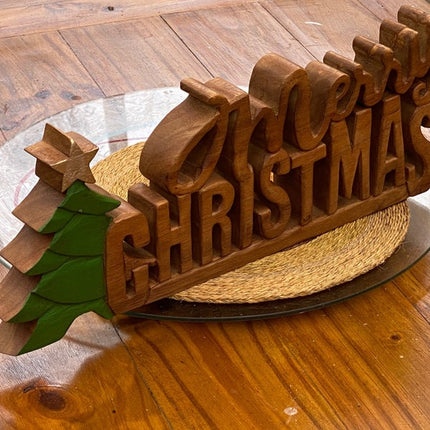 Wooden carved Merry Christmas decoration 38 cm long with Tree and Star.