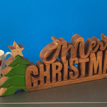 Wooden carved Merry Christmas decoration 38 cm long with Tree and Star.