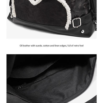 Stylish black tote backpack with heart embellishment - can be worn on one shoulder or as a backpack.