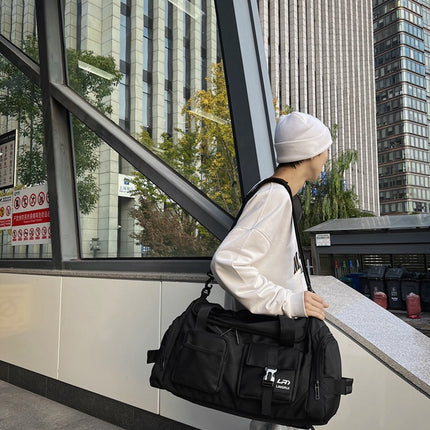 Black Unisex Travel Bag with Utility Buckles and Wet/Dry Compartments.