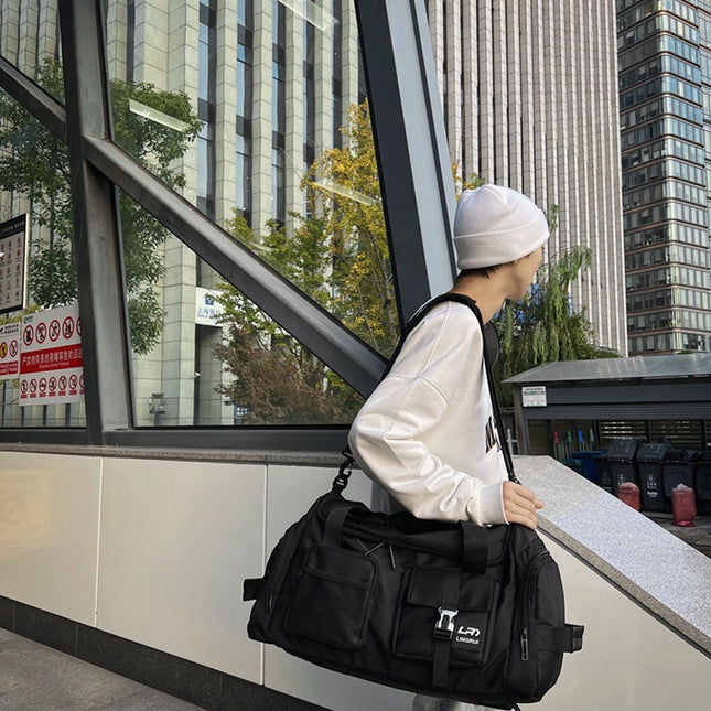 Black Unisex Travel Bag with Utility Buckles and Wet/Dry Compartments.