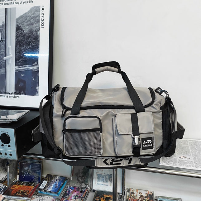 Grey Unisex Travel Bag with Utility Buckles and Wet/Dry Compartments.