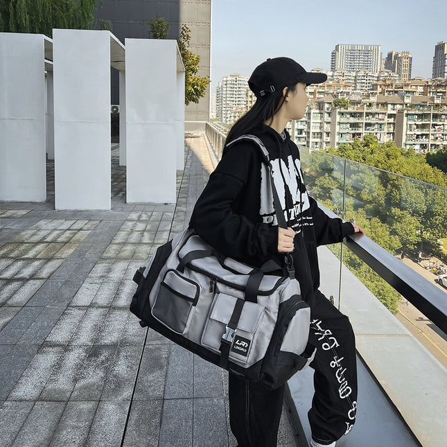Grey Unisex Travel Bag with Utility Buckles and Wet/Dry Compartments.