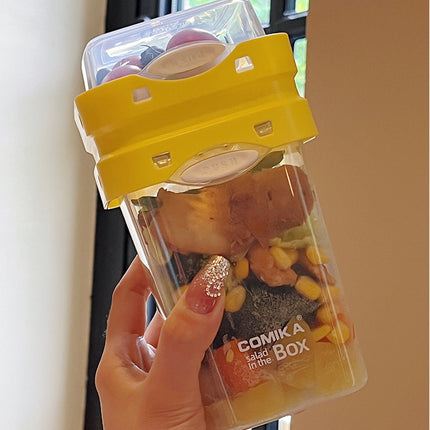 Yellow Portable salad cup with ingredient compartment and fork and spoon - enjoy breakfast on the go.