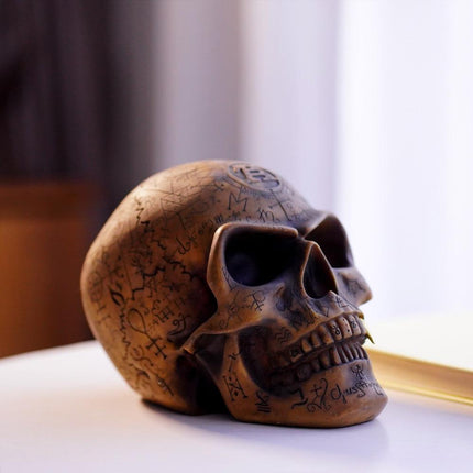 Mystic Runic Skull Statue with Gold Fang - Hand-Painted Resin Figurine for Gothic & Halloween Decor.