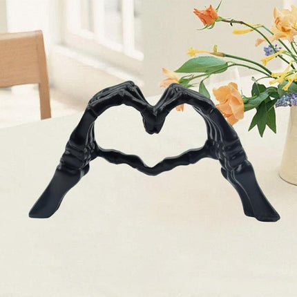 Black Gothic Skeleton Hands Heart Sculpture - Macabre Love Figurine for Home & Halloween Decor.