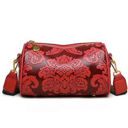 Red Vintage Embossed Crossbody Barrel Bag with Wide Adjustable Guitar Strap.