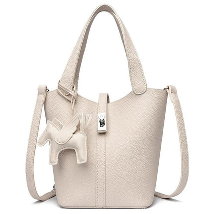 Beige Women's Small PU Leather Bucket Bag with Secure Lock and Horse Charm - 20cm Compact Crossbody Handbag for Everyday Use.