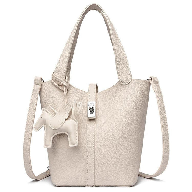 Beige Women's Small PU Leather Bucket Bag with Secure Lock and Horse Charm - 20cm Compact Crossbody Handbag for Everyday Use.