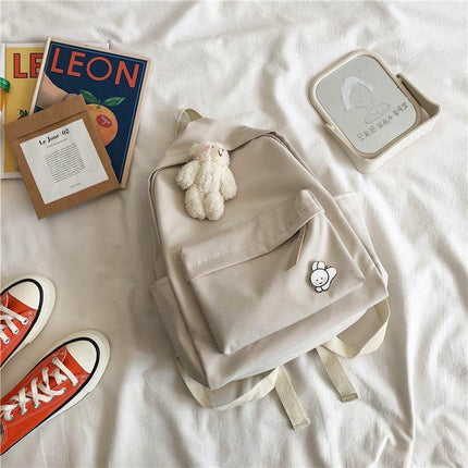 Aesthetic Off-white School Backpack with Cute Bear Plushie and Pin Large Capacity Nylon Laptop Daypack for High School and Uni Students.