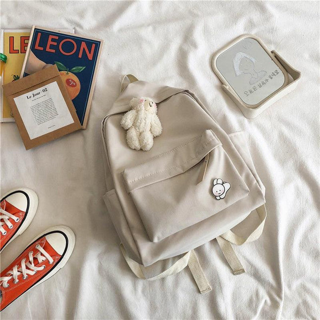 Aesthetic Off-white School Backpack with Cute Bear Plushie and Pin Large Capacity Nylon Laptop Daypack for High School and Uni Students.