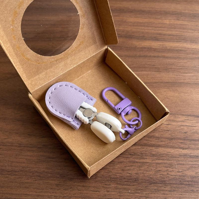 Purple Ultra-Portable Mini Precision Scissors Set - Compact 7cm Craft Snips with Safety Cap, Leather Sheath, and Keychain Hook for Travel and DIY.