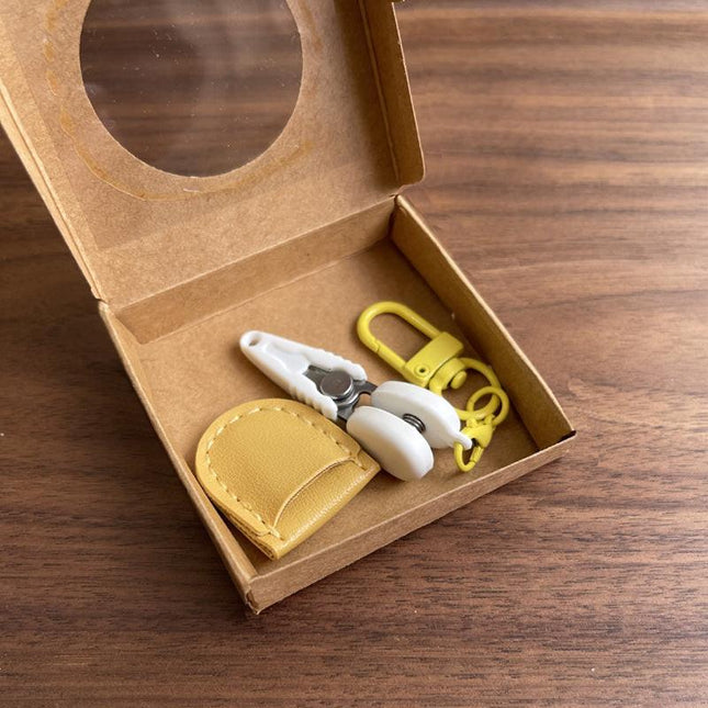 Yellow Ultra-Portable Mini Precision Scissors Set - Compact 7cm Craft Snips with Safety Cap, Leather Sheath, and Keychain Hook for Travel and DIY.